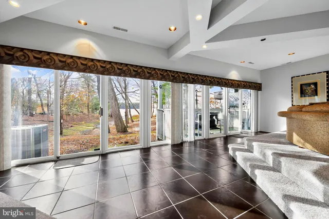 a view of an entryway with a floor to ceiling window and wooden floor