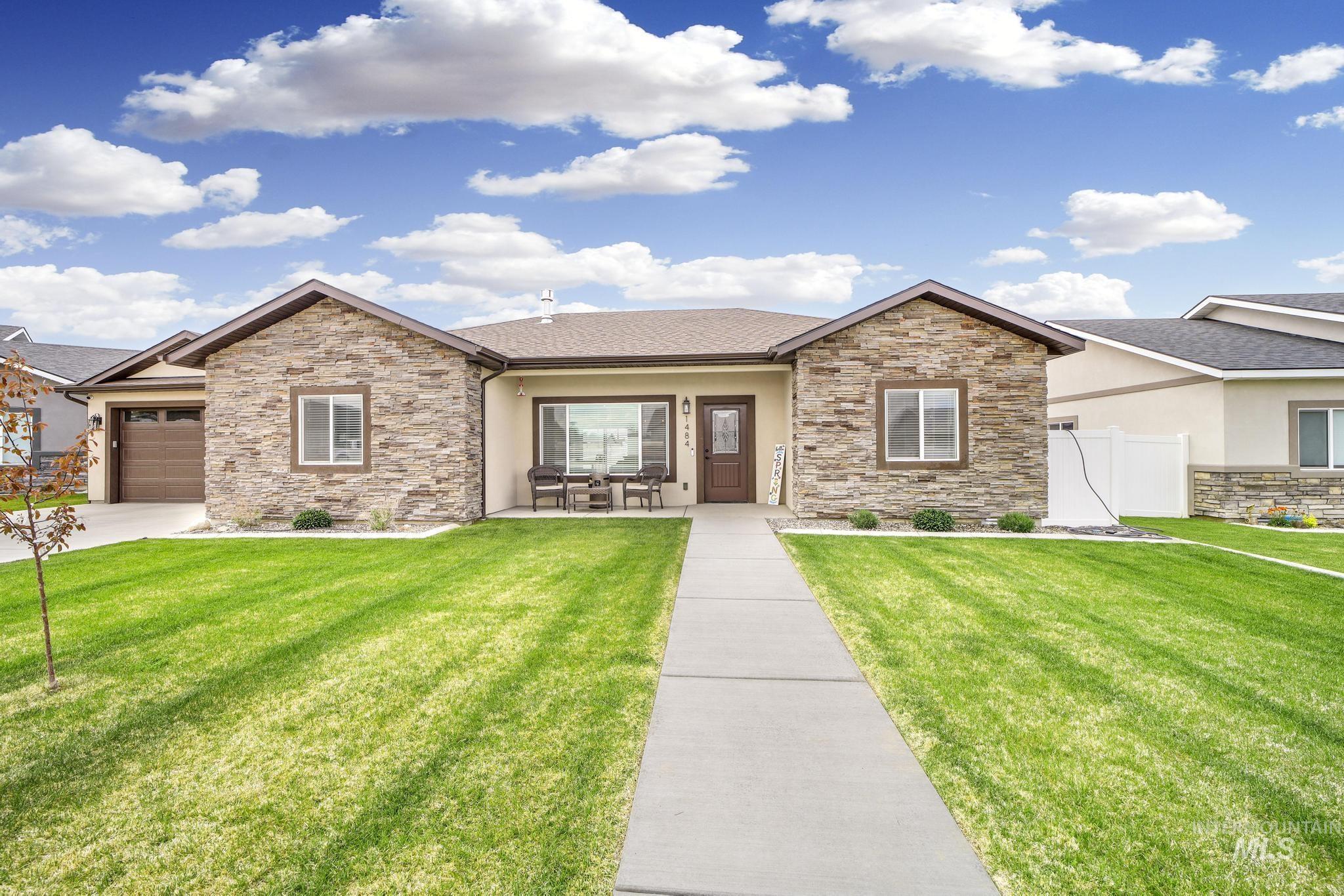 284 Sandi Road Twin Falls, ID 83301 - Photo 2 of 22 View of front of house featuring stone siding, stucco siding, roof with shingles, and covered porch
