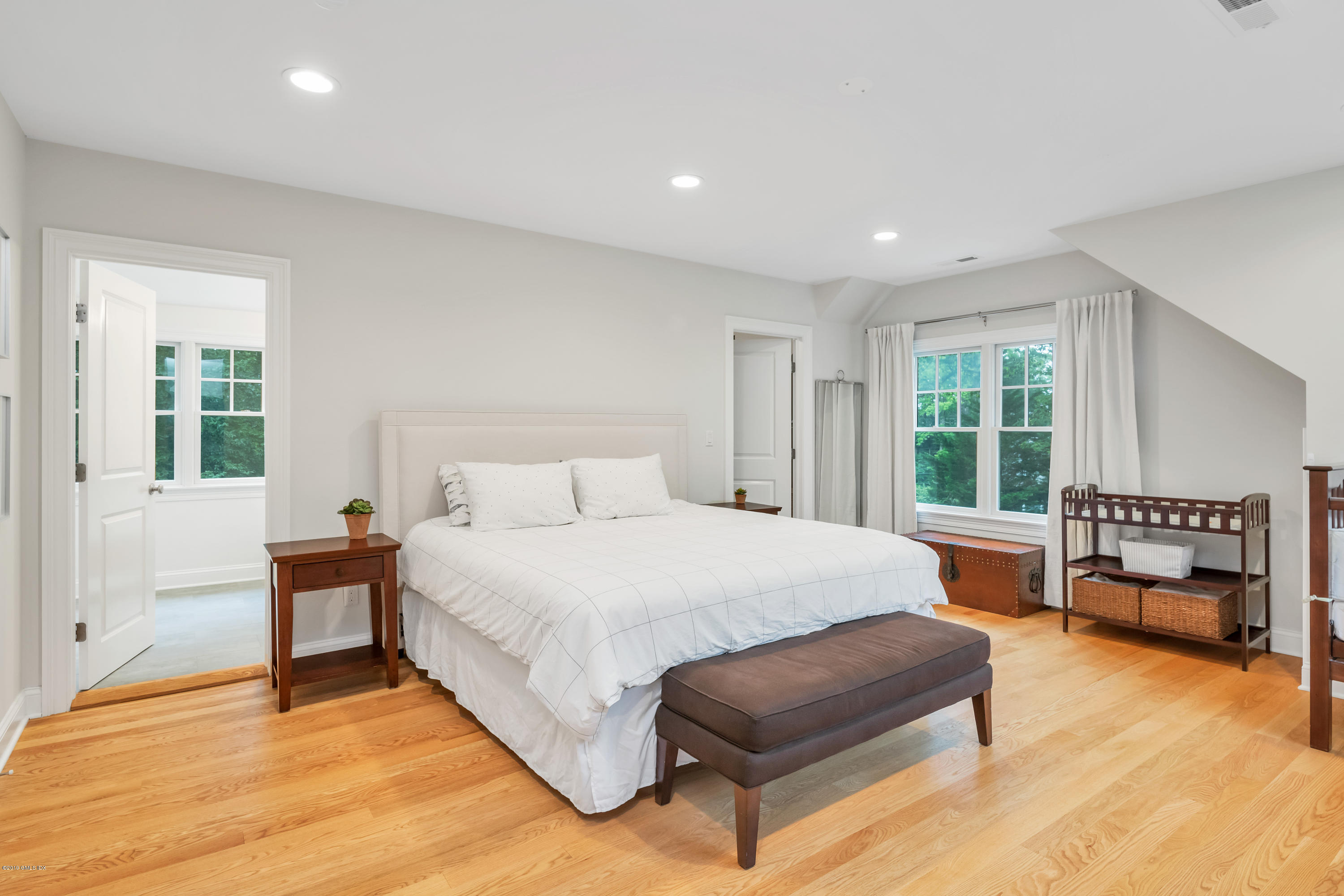 94 Cognewaugh Road Cos Cob, CT 06807 - Photo 13 of 25 a spacious bedroom with a bed and a table in it