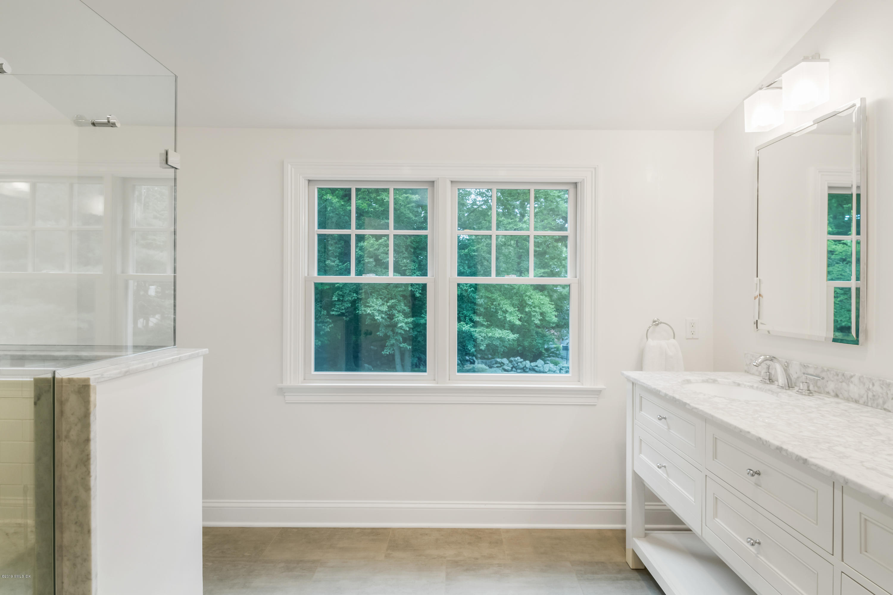 94 Cognewaugh Road Cos Cob, CT 06807 - Photo 16 of 25 a bathroom with a sink and a window