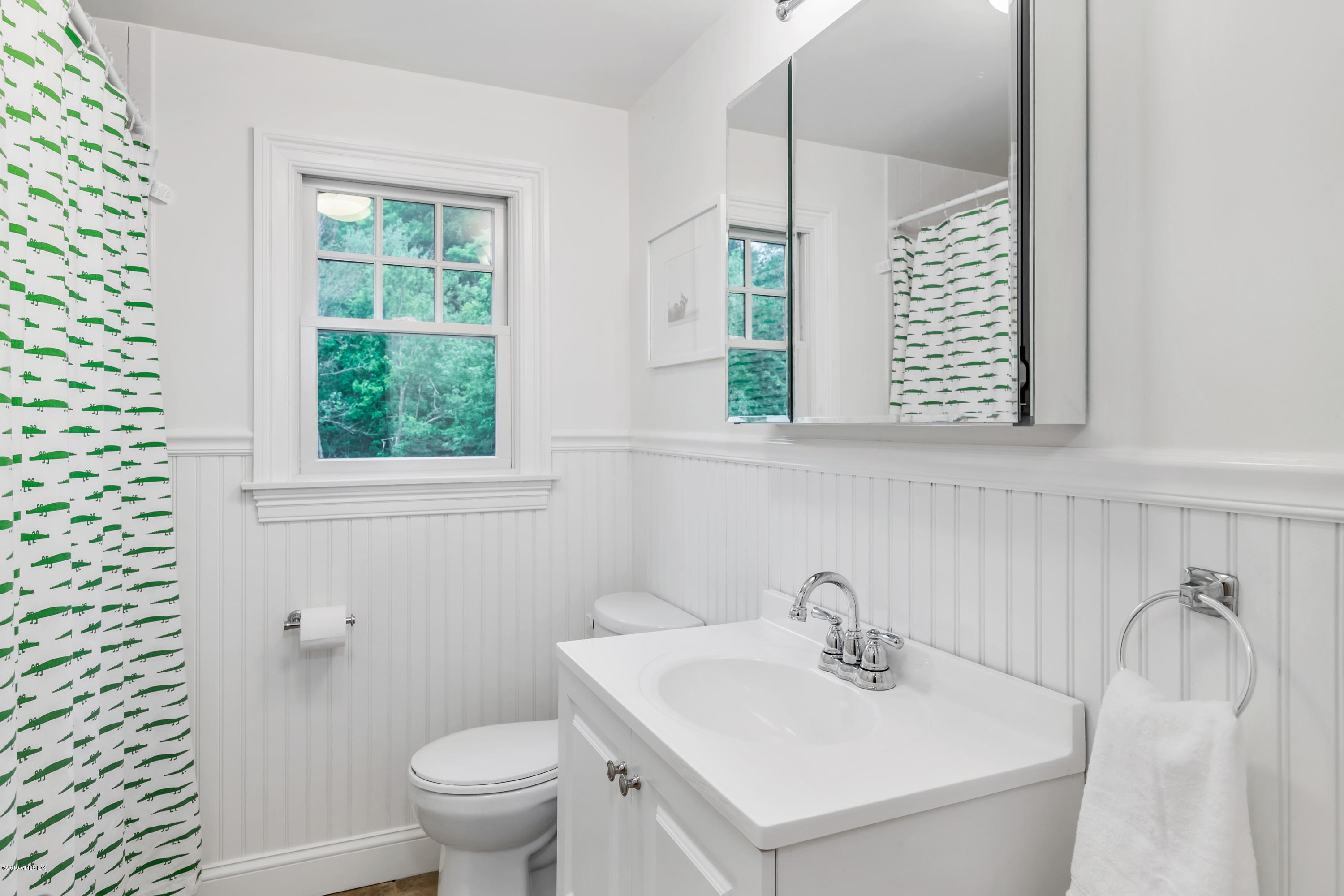 94 Cognewaugh Road Cos Cob, CT 06807 - Photo 17 of 25 a bathroom with a sink a toilet and a mirror
