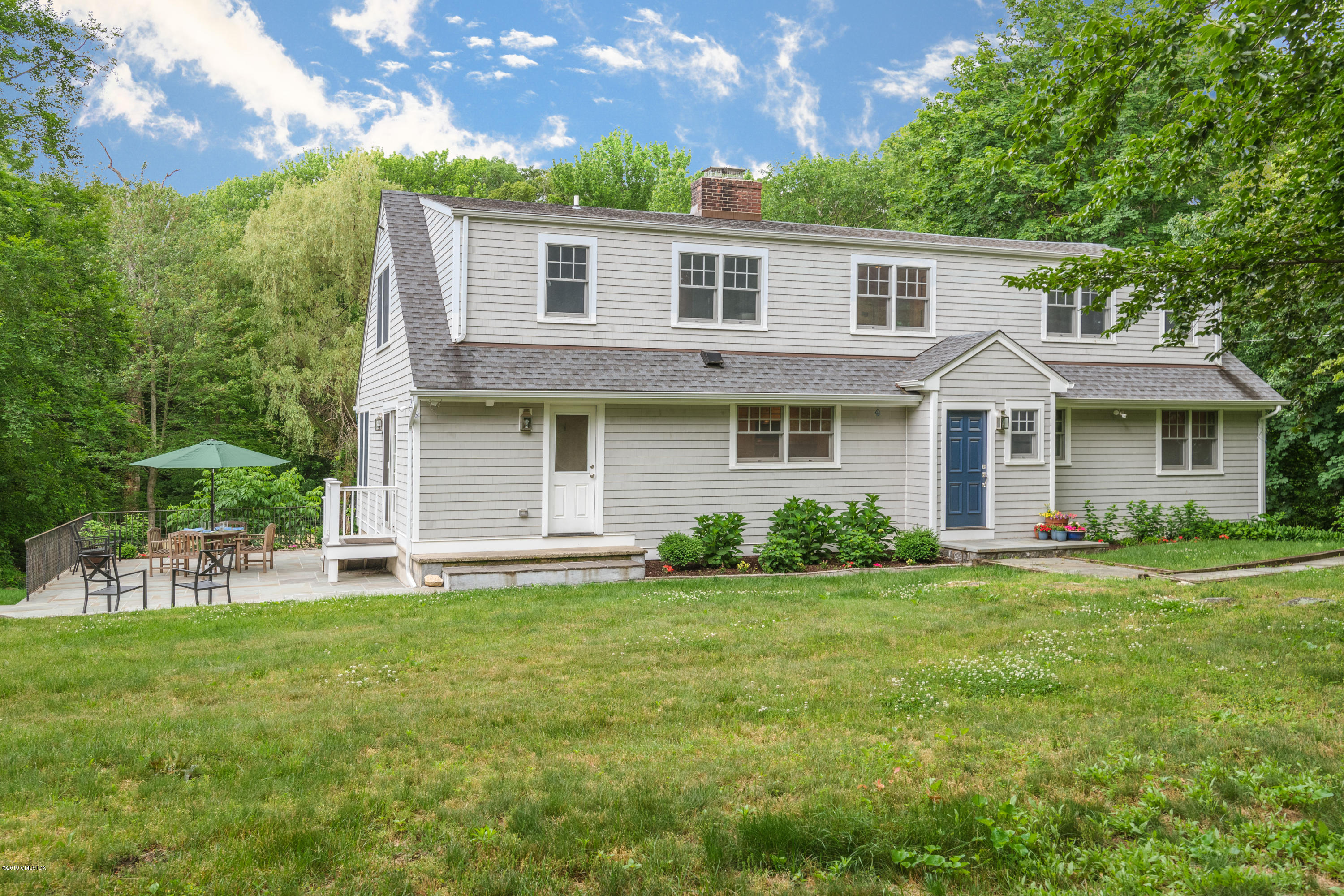 94 Cognewaugh Road Cos Cob, CT 06807 - Photo 2 of 25 a front view of a house with a garden