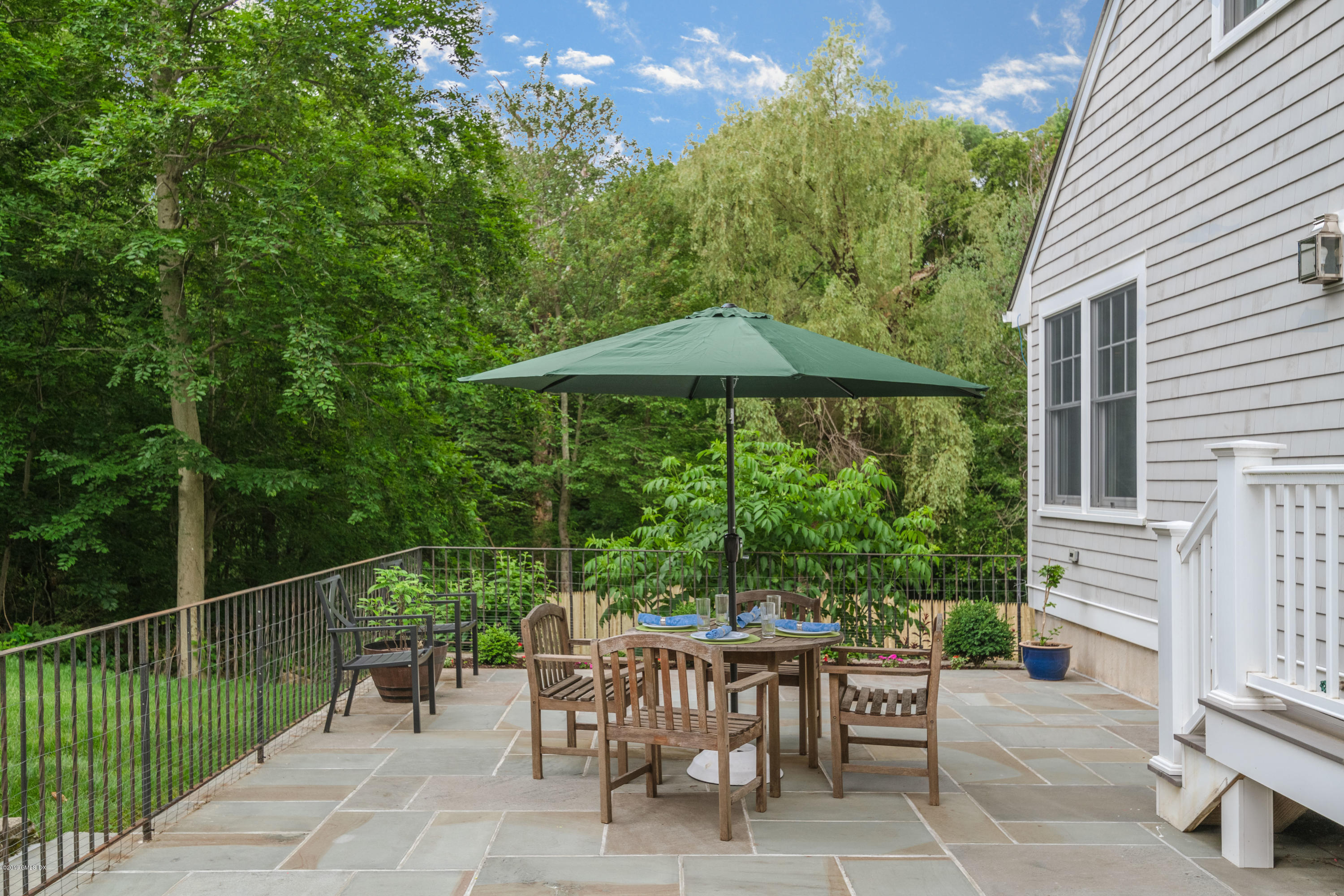 94 Cognewaugh Road Cos Cob, CT 06807 - Photo 23 of 25 a view of a chairs and table in backyard