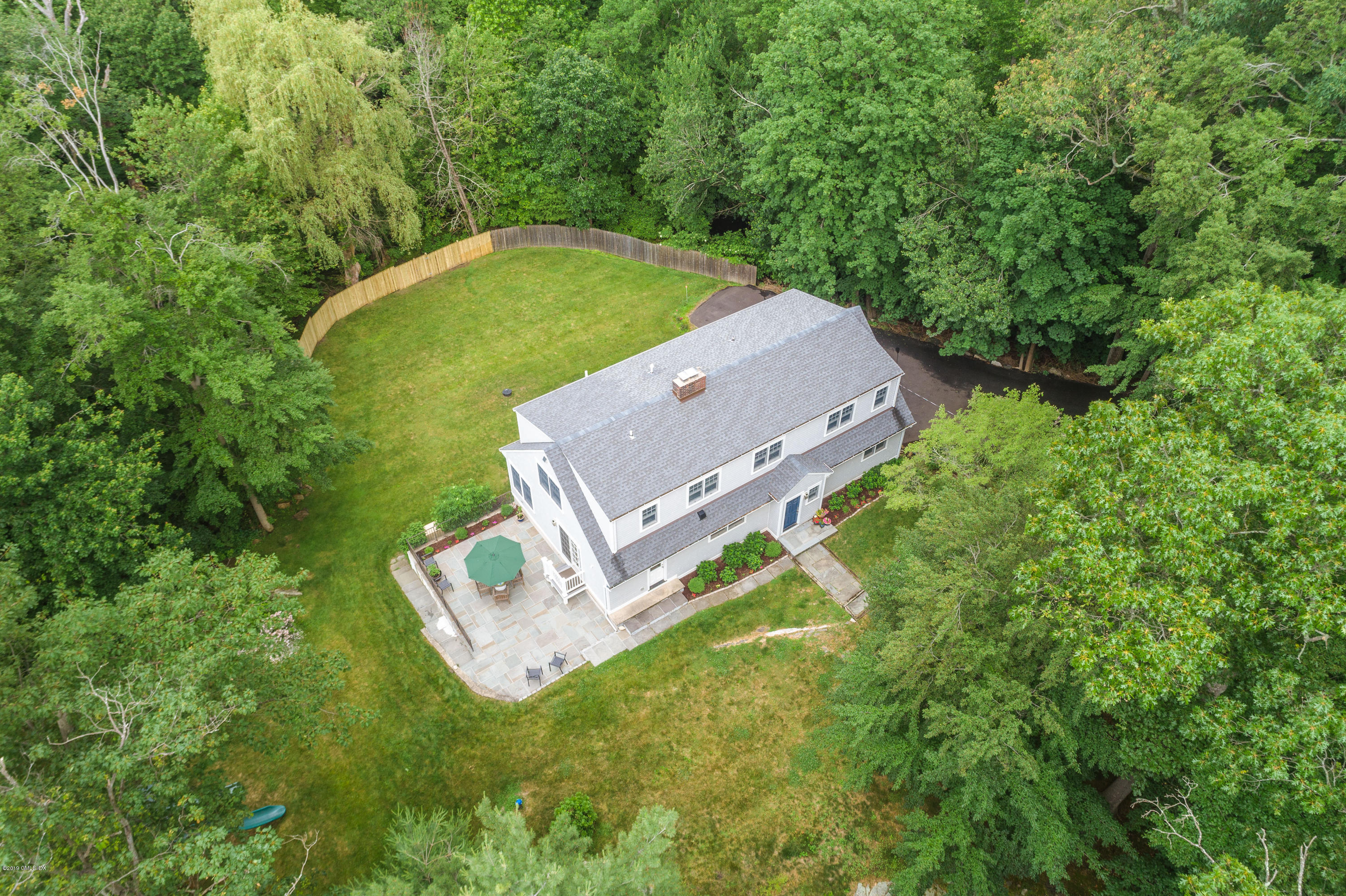 94 Cognewaugh Road Cos Cob, CT 06807 - Photo 24 of 25 a view of a house with a backyard
