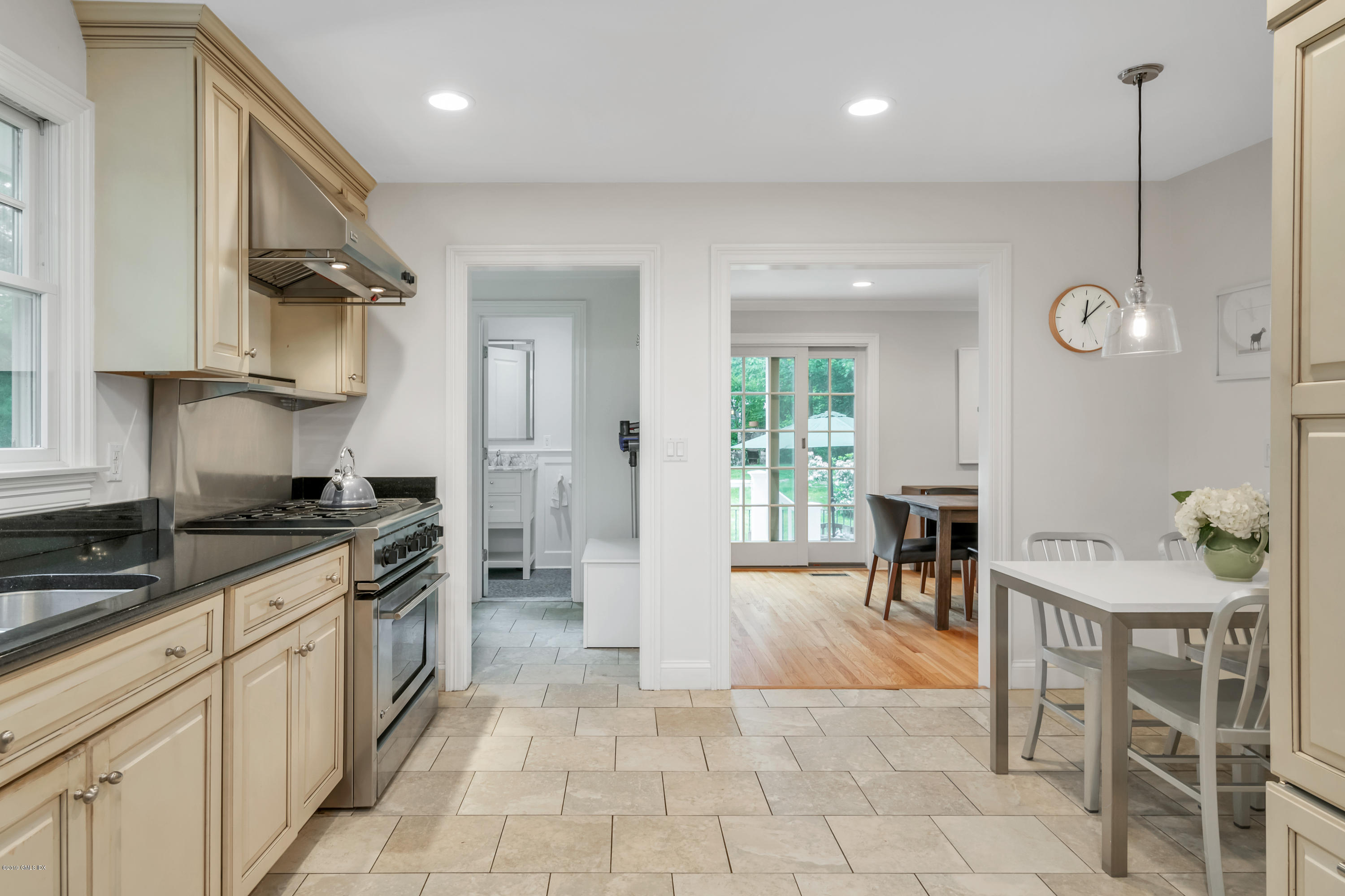 94 Cognewaugh Road Cos Cob, CT 06807 - Photo 5 of 25 a kitchen with stainless steel appliances granite countertop a stove a sink dishwasher and a refrigerator with wooden floor
