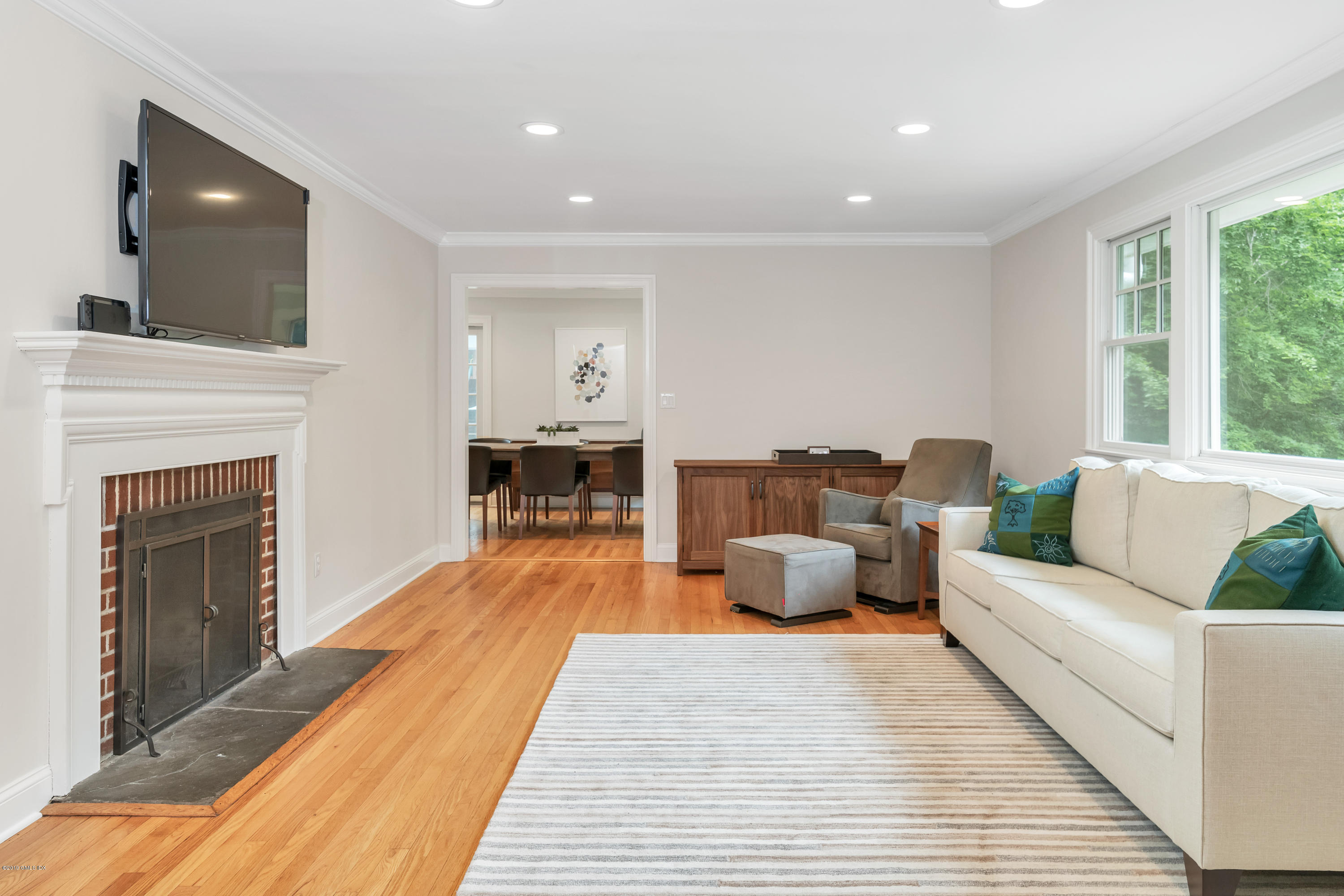 94 Cognewaugh Road Cos Cob, CT 06807 - Photo 10 of 25 a living room with furniture and a fireplace
