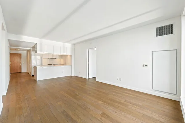 a view of a kitchen with a sink and a refrigerator