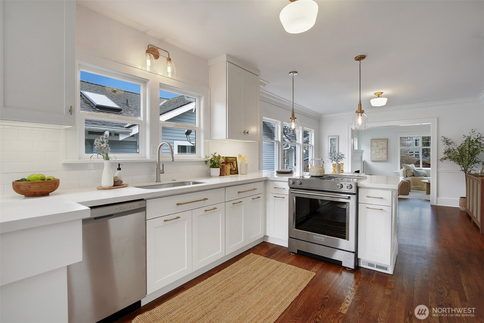 720 North 46th Street Seattle, WA 98103 - Photo 15 of 32 a kitchen with a sink cabinets and wooden floor