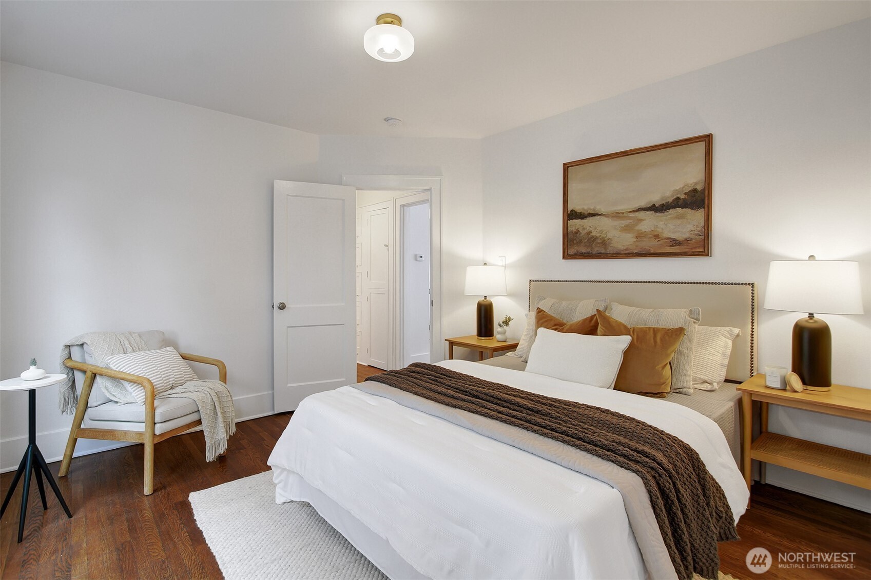 720 North 46th Street Seattle, WA 98103 - Photo 20 of 32 a bedroom with a bed and wooden floor