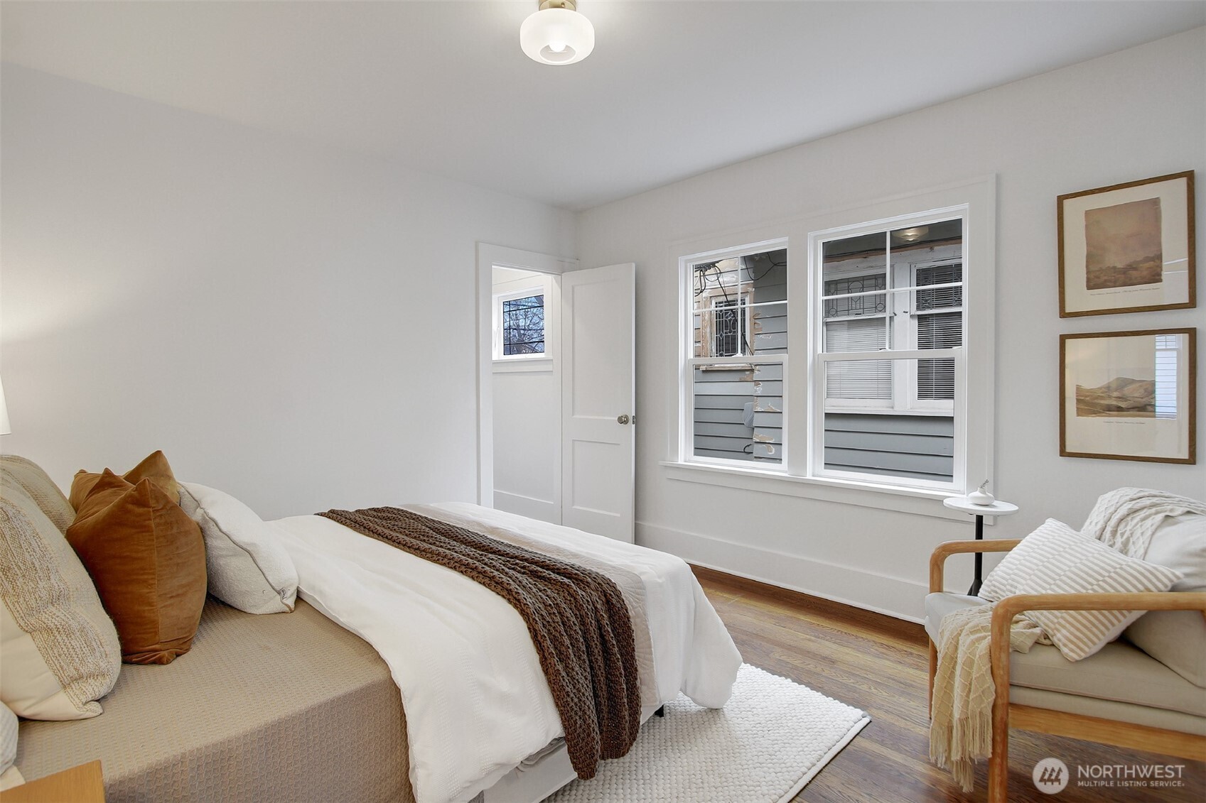 720 North 46th Street Seattle, WA 98103 - Photo 21 of 32 a bedroom with a bed and wooden floor