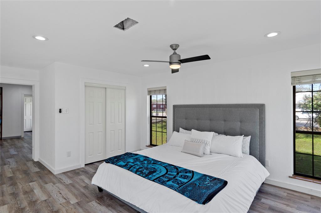 1400 East Shady Grove Road Irving, TX 75060 - Photo 11 of 39 a bedroom with a bed a dresser and a window