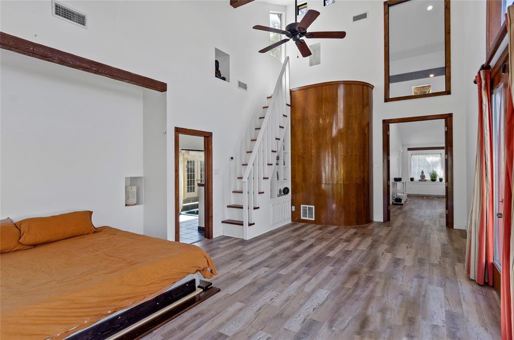 1400 East Shady Grove Road Irving, TX 75060 - Photo 18 of 39 a bedroom with a bed and a mirror