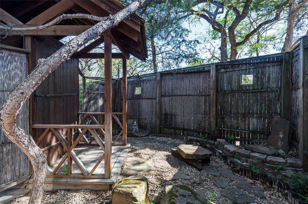 1400 East Shady Grove Road Irving, TX 75060 - Photo 30 of 39 a view of a backyard with table and chairs potted plants and wooden fence