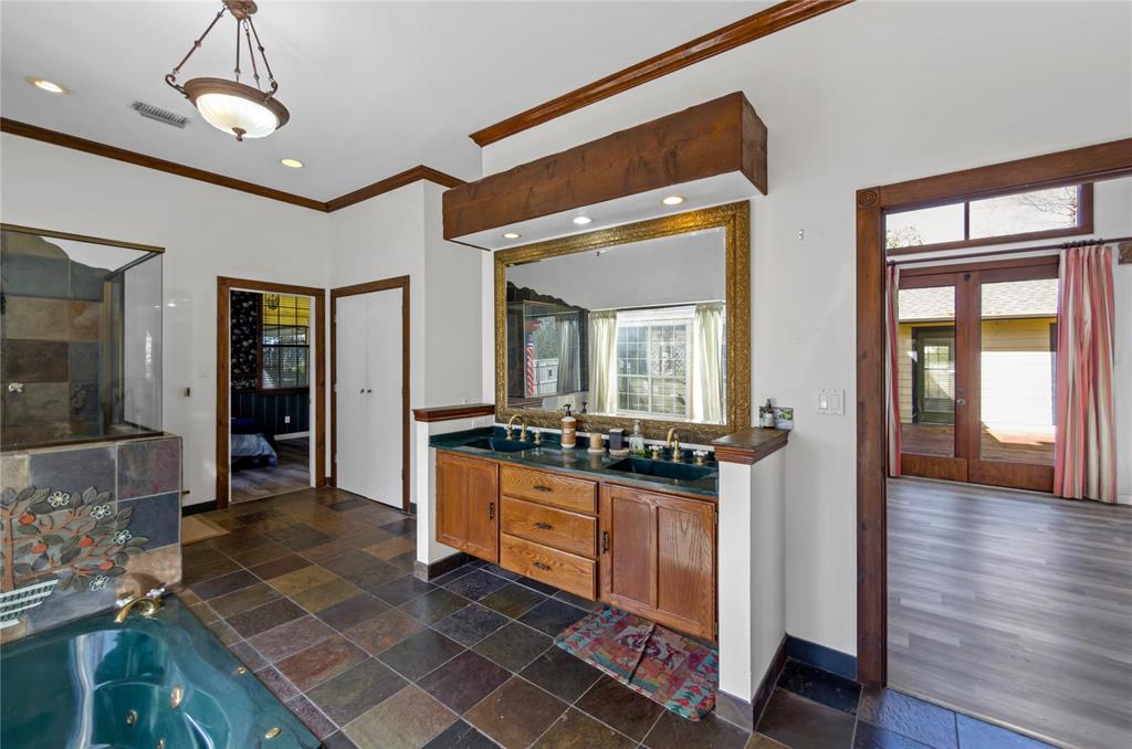 1400 East Shady Grove Road Irving, TX 75060 - Photo 35 of 39 a hallway with a sink and a mirror
