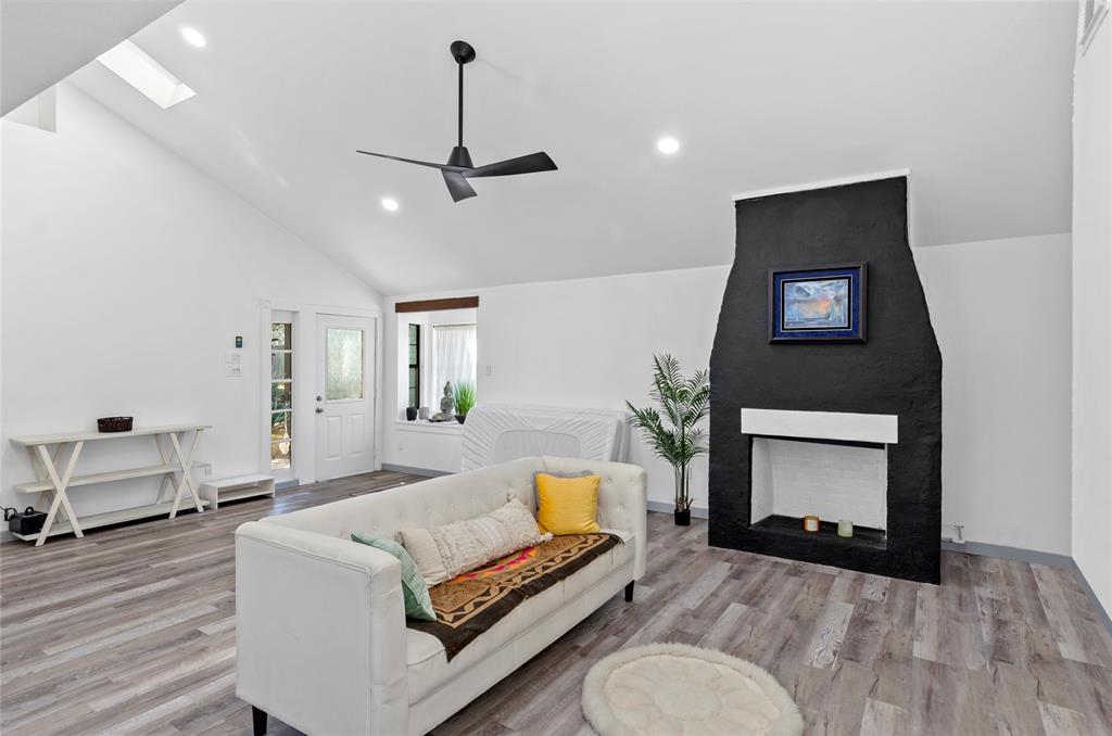1400 East Shady Grove Road Irving, TX 75060 - Photo 6 of 39 a living room with furniture and a fireplace