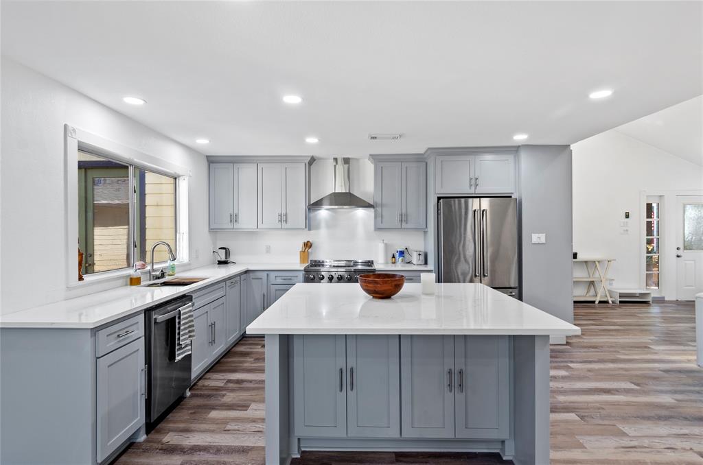 1400 East Shady Grove Road Irving, TX 75060 - Photo 7 of 39 a kitchen with a sink a stove a refrigerator and cabinets