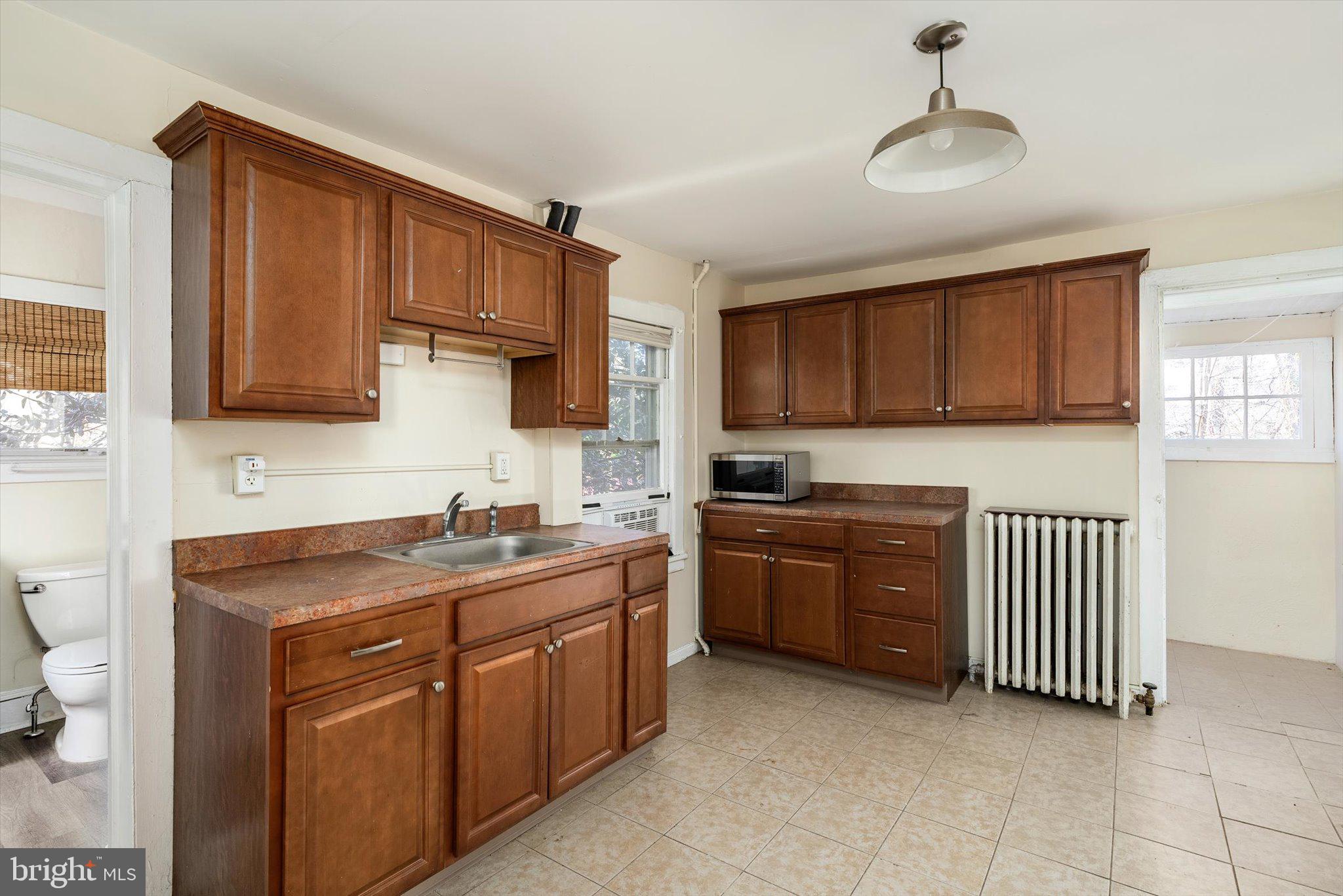 75 Patton Avenue, Unit 1 Princeton, NJ 08540 - Photo 8 of 20 a kitchen with a sink stove and cabinets