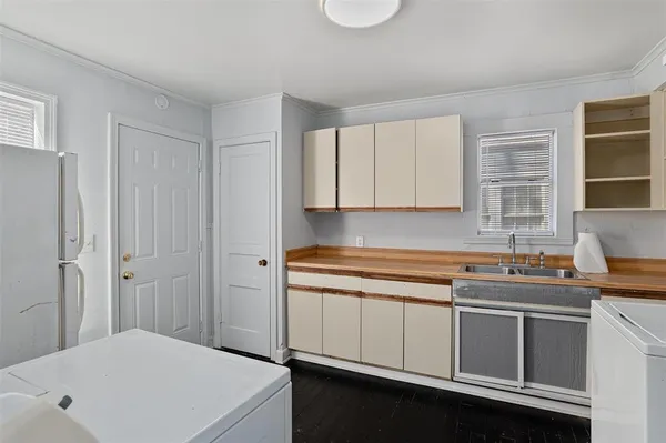 a kitchen with a sink stove and cabinets