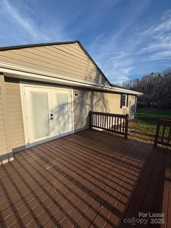 a view of a balcony with wooden floor