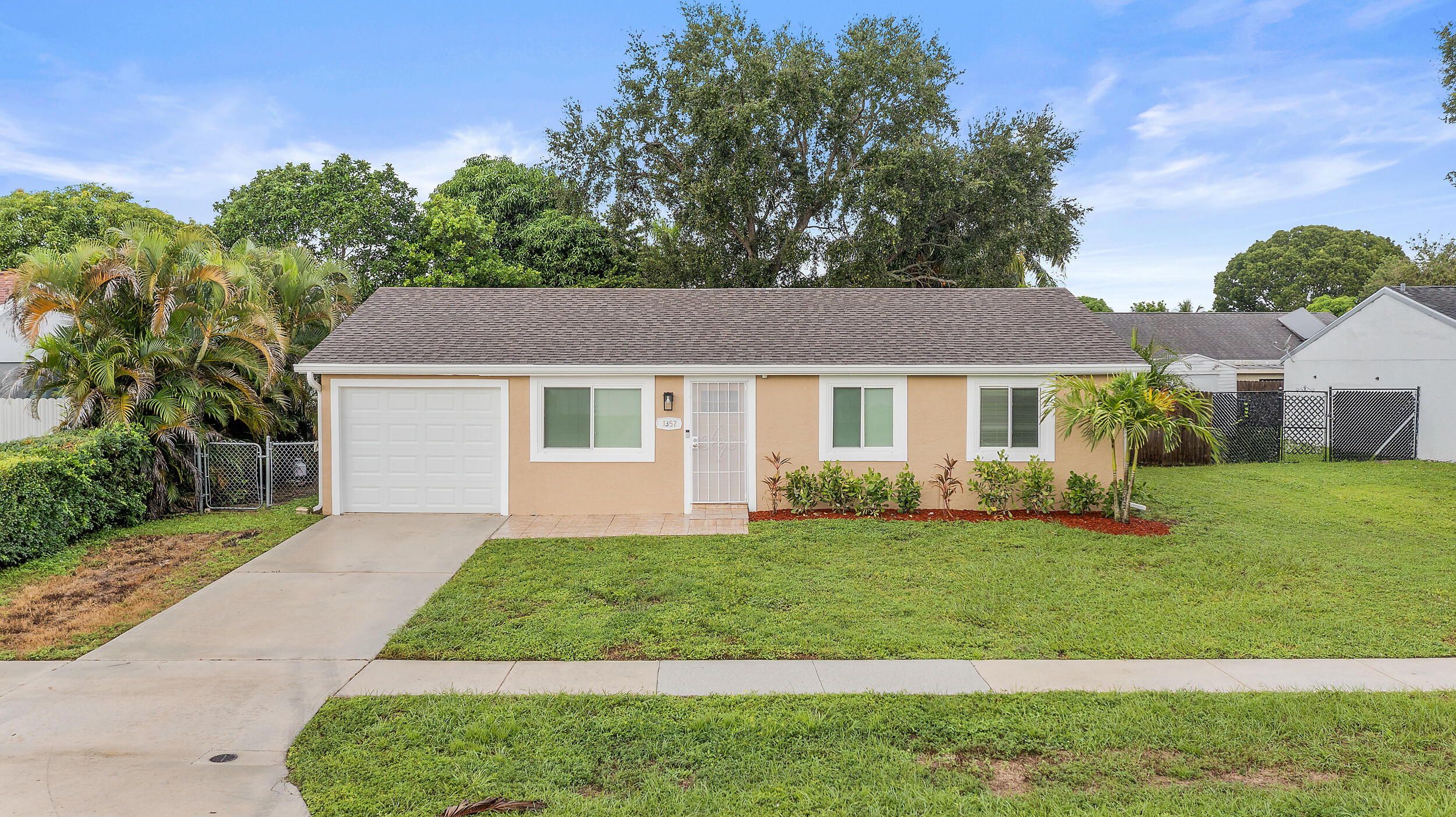 1357 Ryan Lane Royal Palm Beach, FL 33411 - Photo 1 of 23 a front view of a house with a yard
