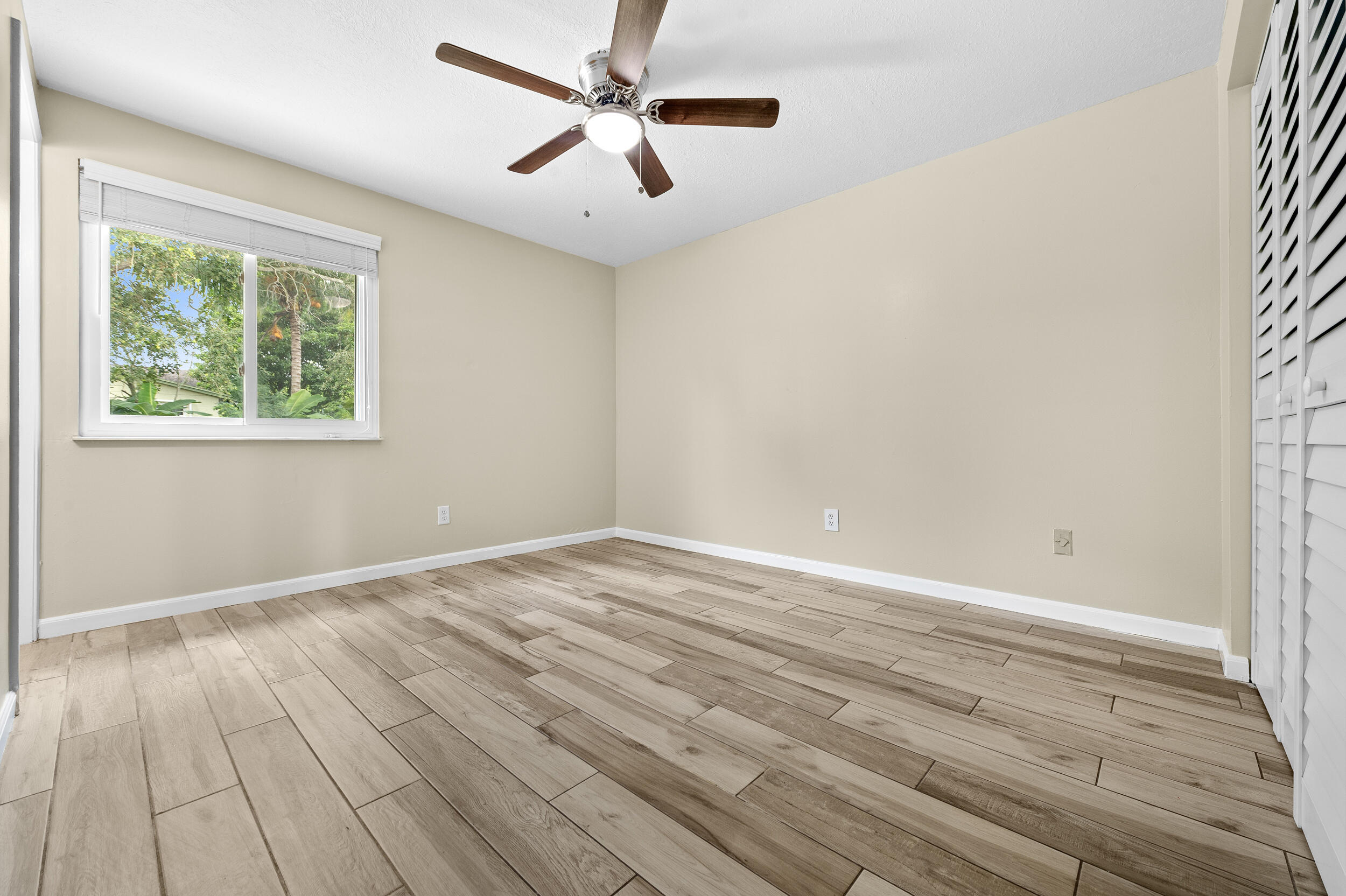 1357 Ryan Lane Royal Palm Beach, FL 33411 - Photo 11 of 23 wooden floor in an empty room with a window