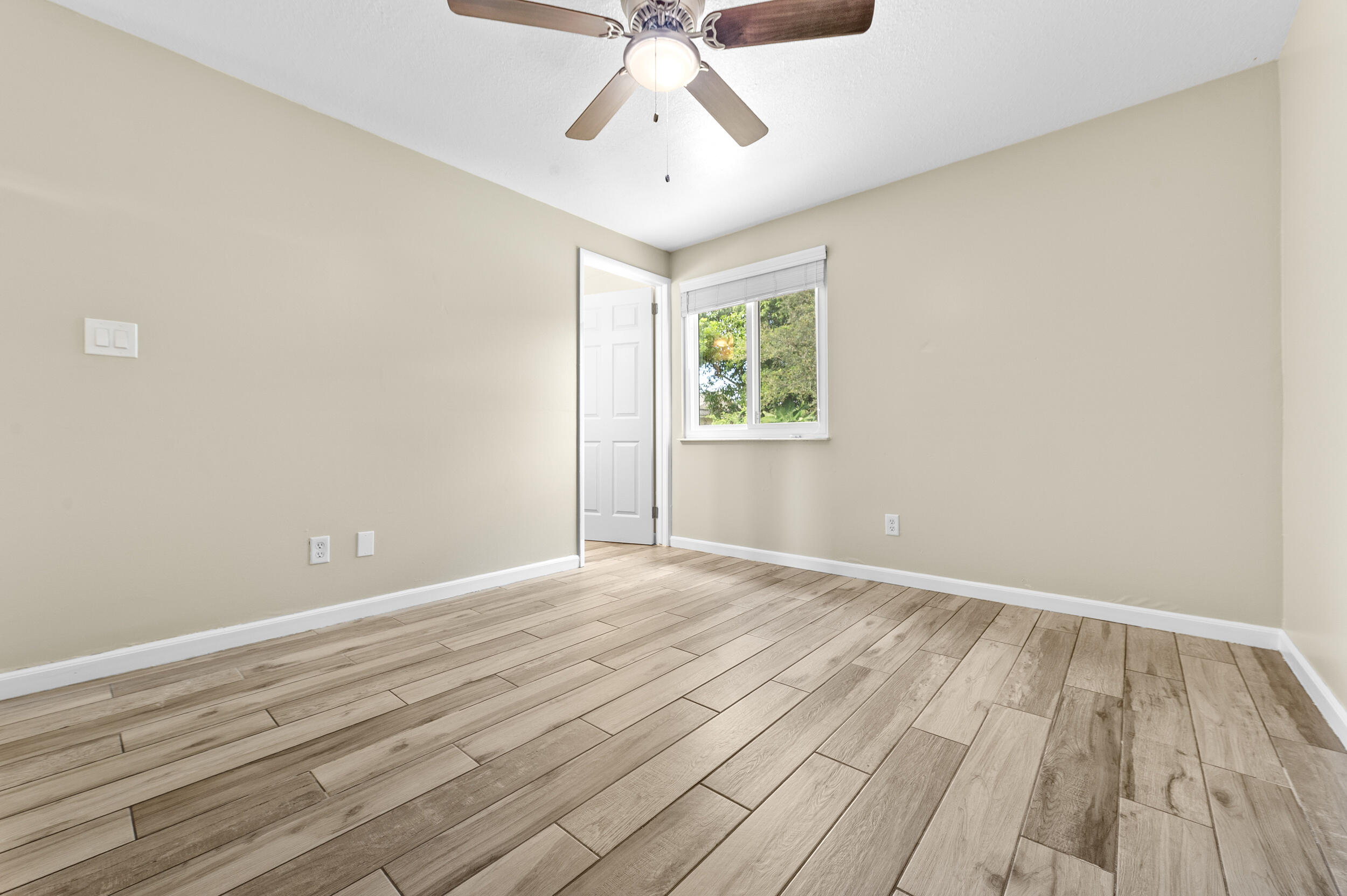 1357 Ryan Lane Royal Palm Beach, FL 33411 - Photo 12 of 23 wooden floor in an empty room with a window