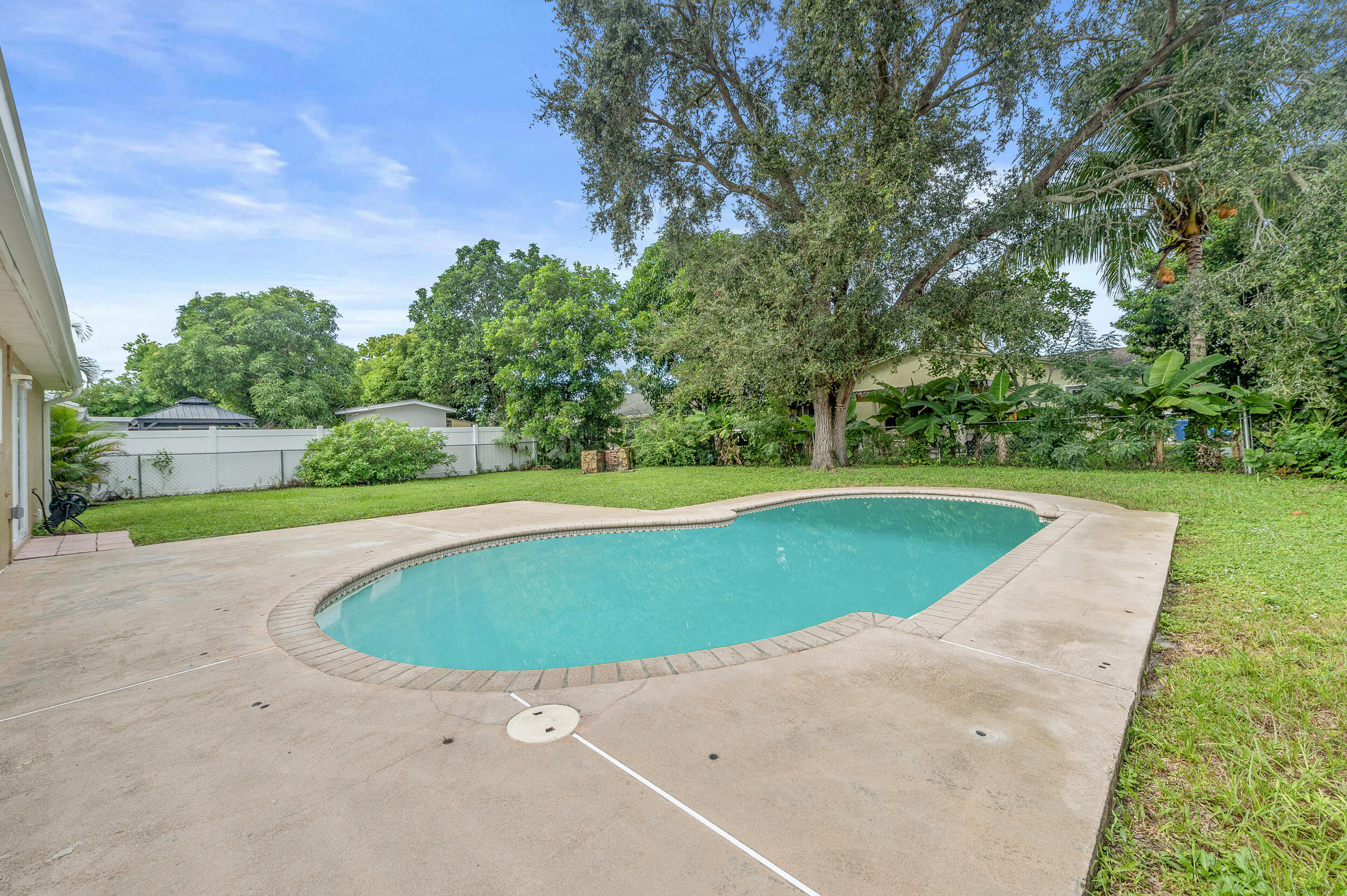 1357 Ryan Lane Royal Palm Beach, FL 33411 - Photo 14 of 23 a view of a swimming pool and a yard