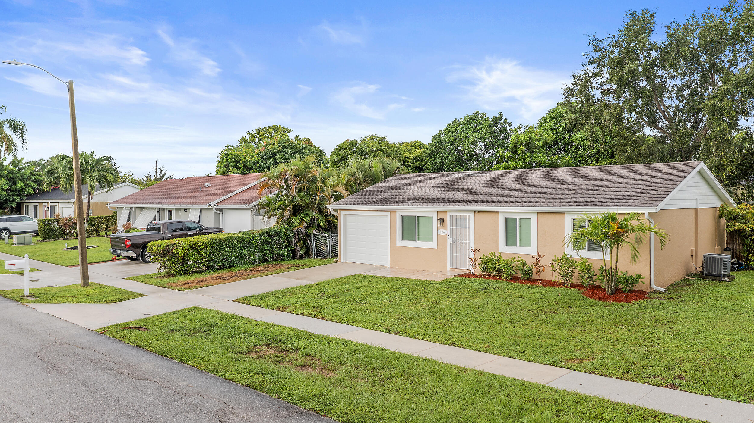1357 Ryan Lane Royal Palm Beach, FL 33411 - Photo 20 of 23 a view of a house with a yard and potted plants