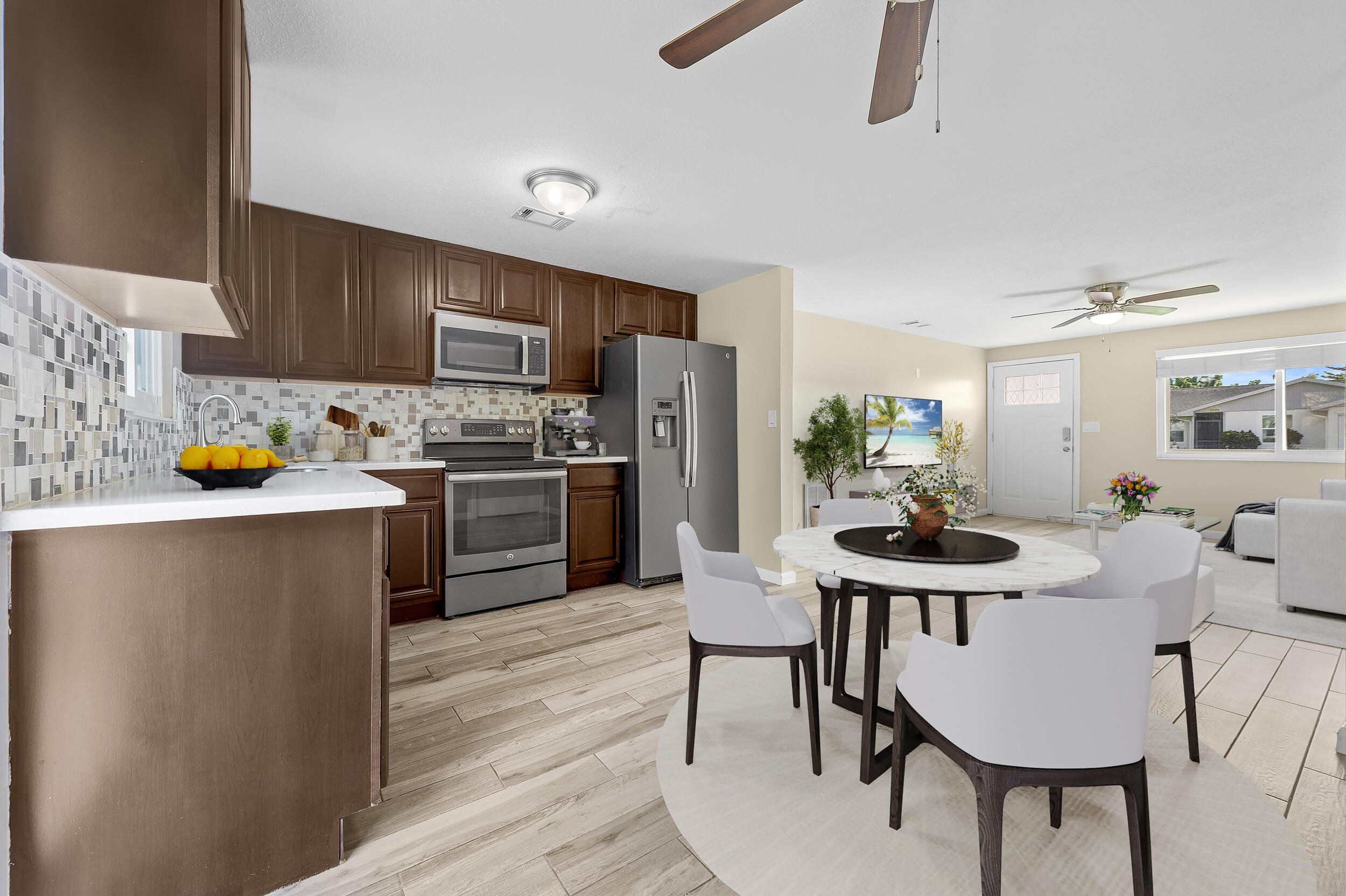 1357 Ryan Lane Royal Palm Beach, FL 33411 - Photo 2 of 23 a kitchen with stainless steel appliances a dining table and chairs