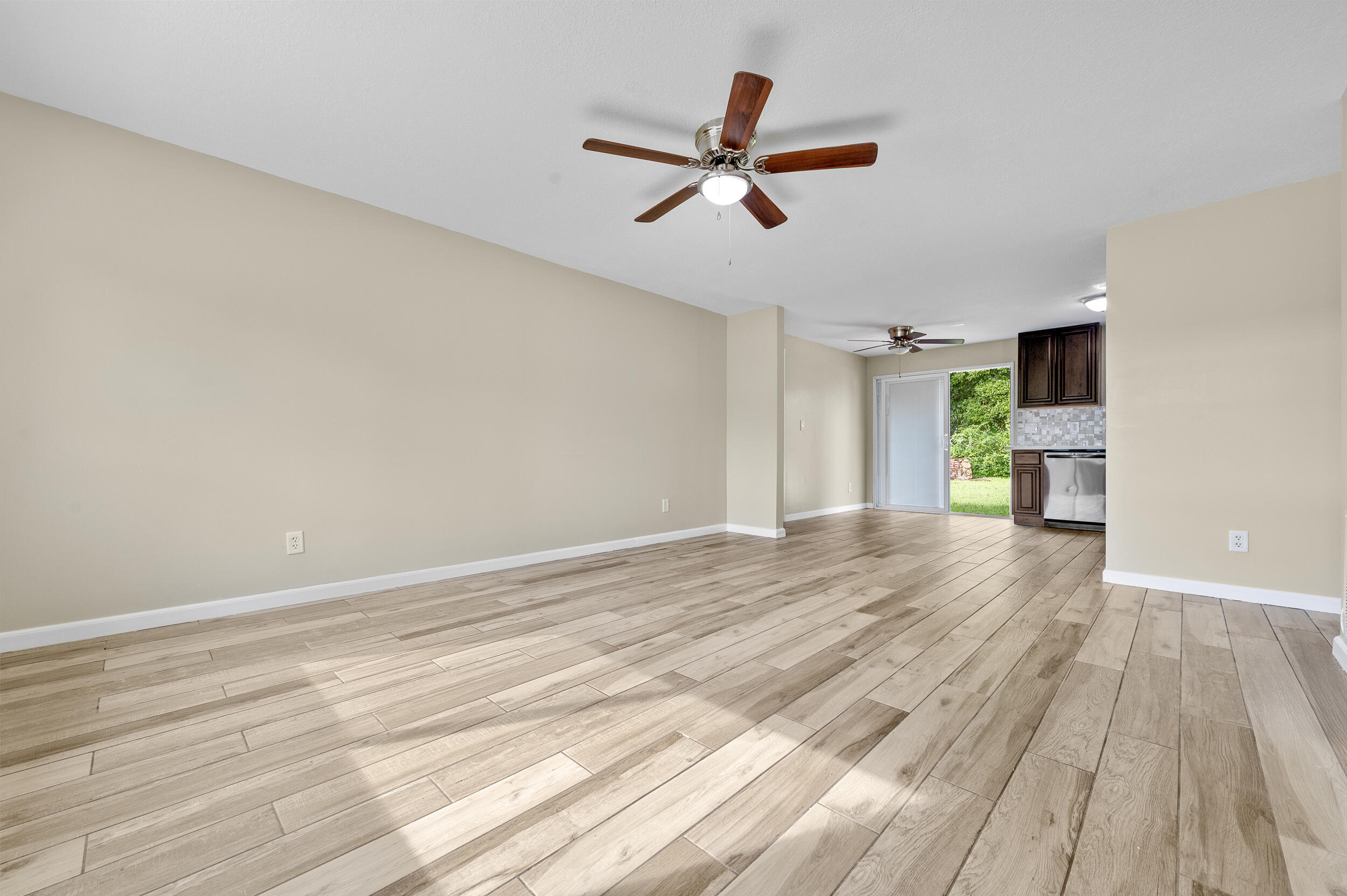 1357 Ryan Lane Royal Palm Beach, FL 33411 - Photo 5 of 23 a view of empty room with wooden floor and ceiling fan