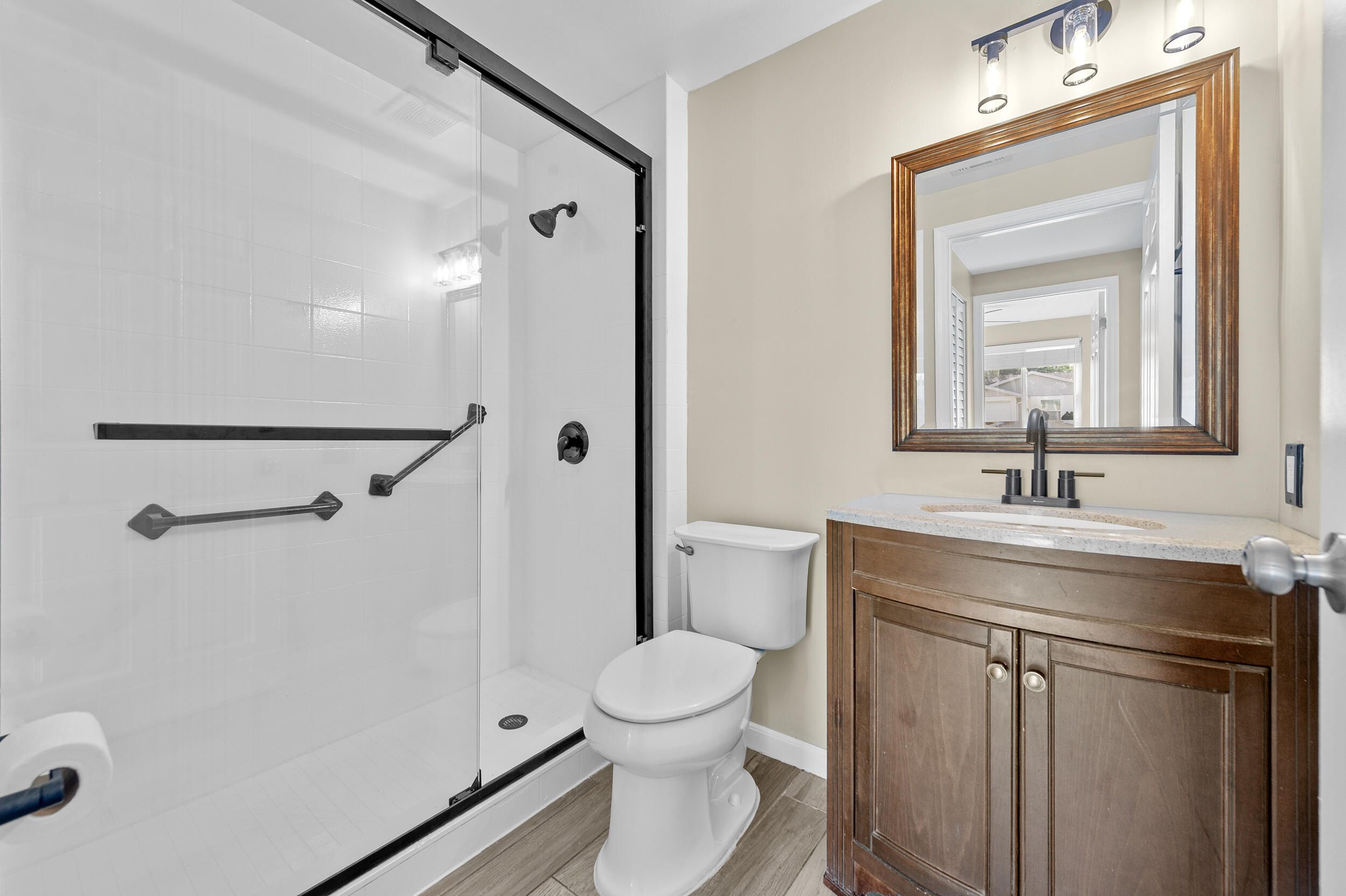 1357 Ryan Lane Royal Palm Beach, FL 33411 - Photo 10 of 23 a bathroom with a toilet sink and a mirror