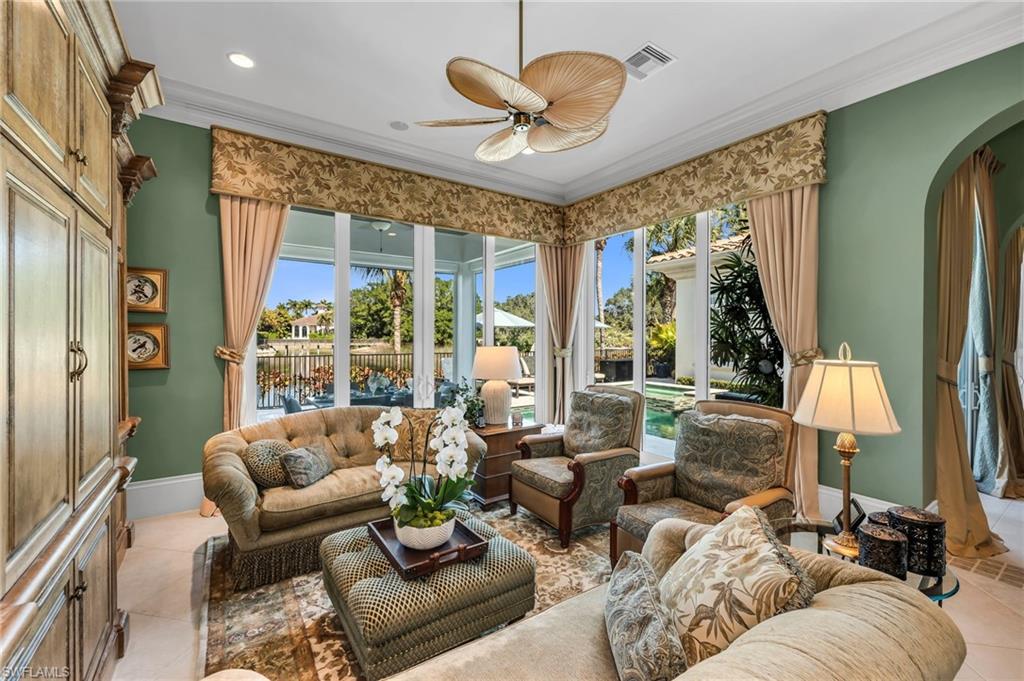 1705 Venezia Way Naples, FL 34105 - Photo 19 of 50 The family room has impact sliders that open out to the lanai, pool and expansive views.