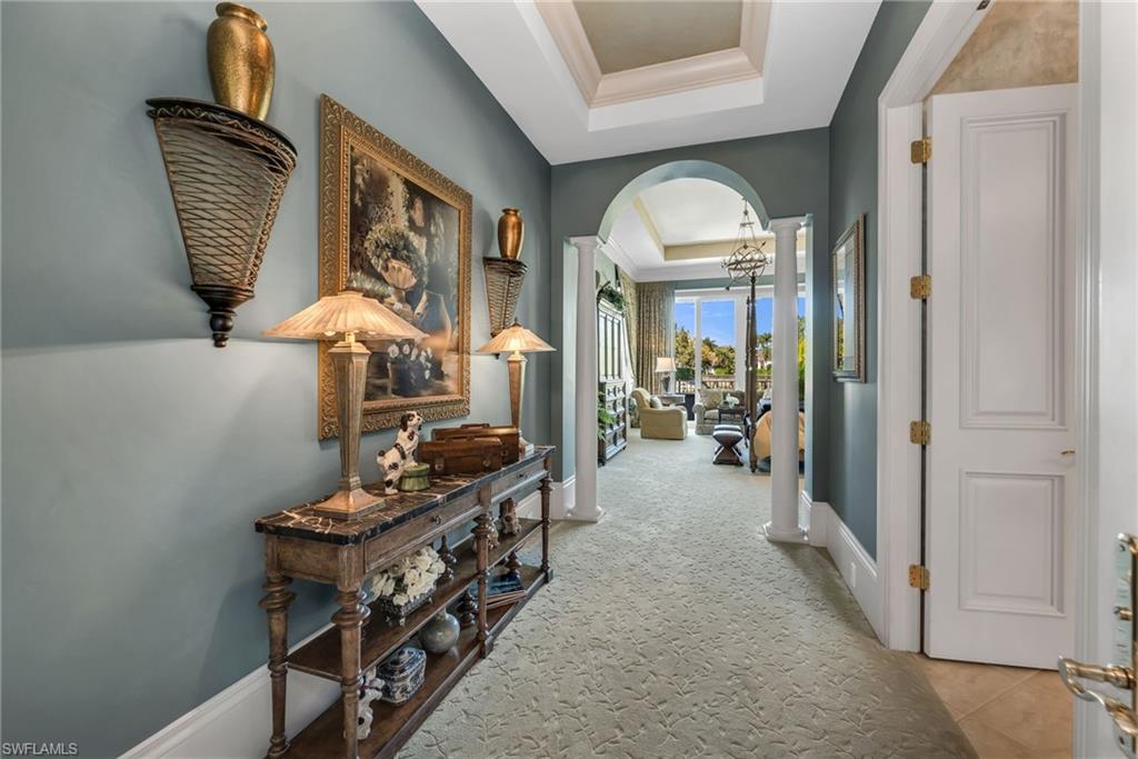 1705 Venezia Way Naples, FL 34105 - Photo 21 of 50 The entry to the Owner's Suite has a large hallway with double French doors at the entryway.