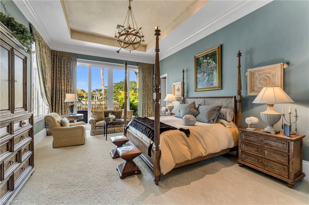 1705 Venezia Way Naples, FL 34105 - Photo 22 of 50 Expansive Owner's Suite with large sitting are and private, lake views.