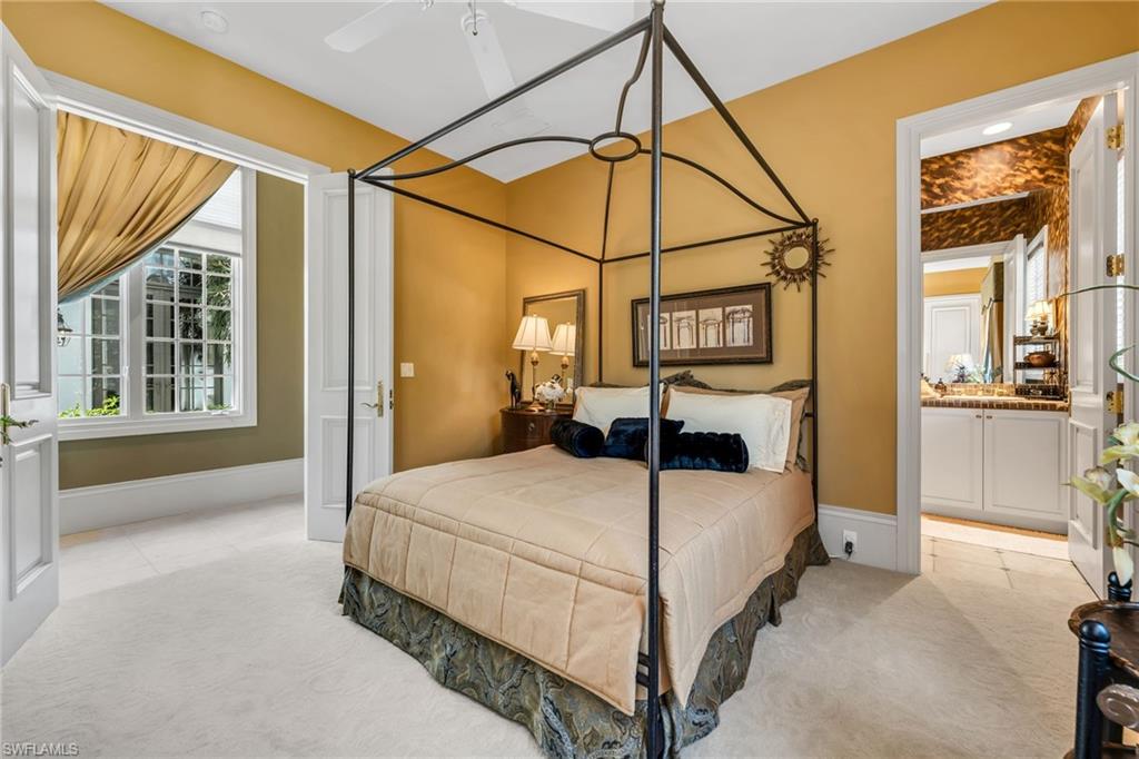 1705 Venezia Way Naples, FL 34105 - Photo 27 of 50 Guest Bedroom with double French doors to the hallway, large, walk-in closet and ensuite bath.