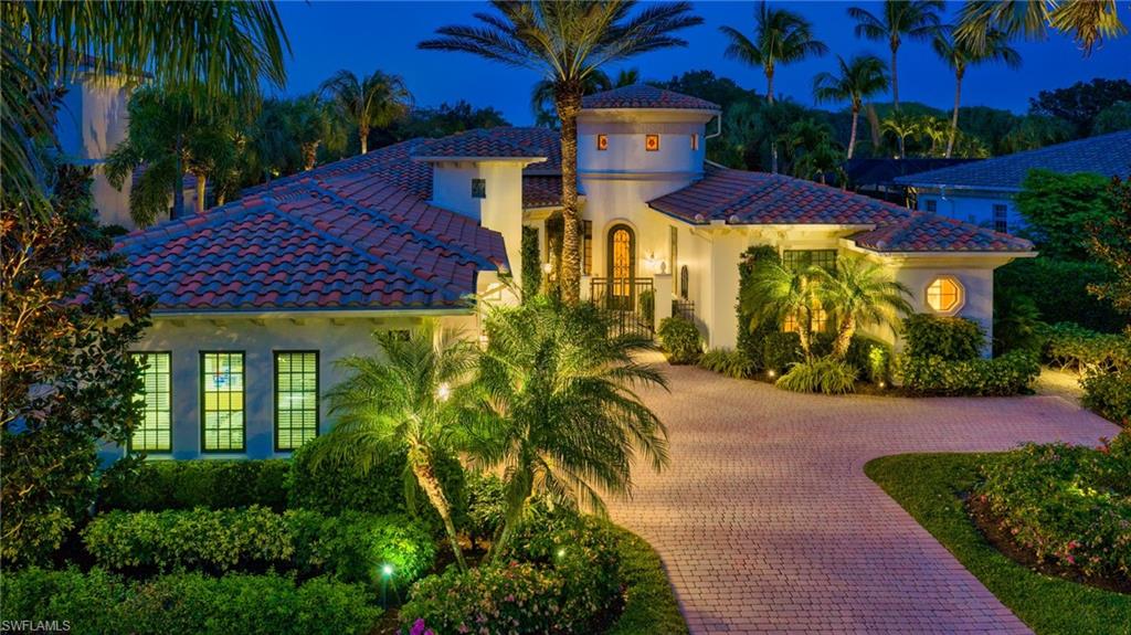 1705 Venezia Way Naples, FL 34105 - Photo 36 of 50 This residence comes to life in the evening, with added landscape lighting around the residence.