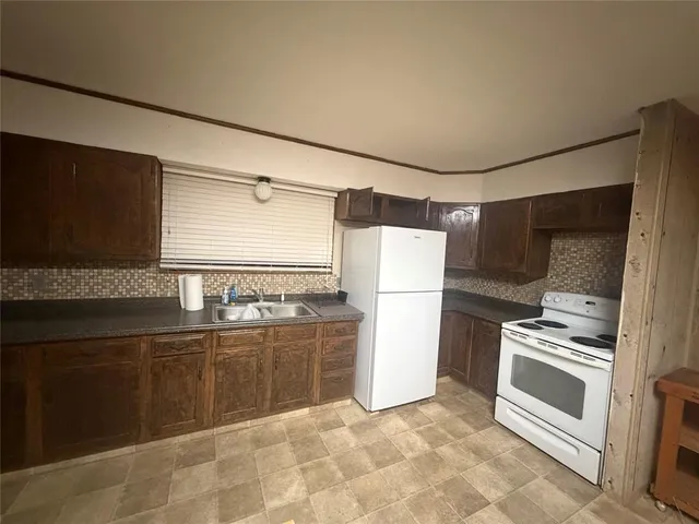 a kitchen with a refrigerator and a stove