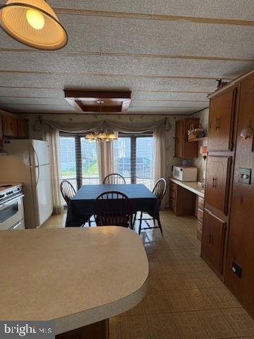 38354 Squirrel Road, Unit 19312 Ocean View, DE 19970 - Photo 16 of 39 a dining room with furniture and a floor to ceiling window