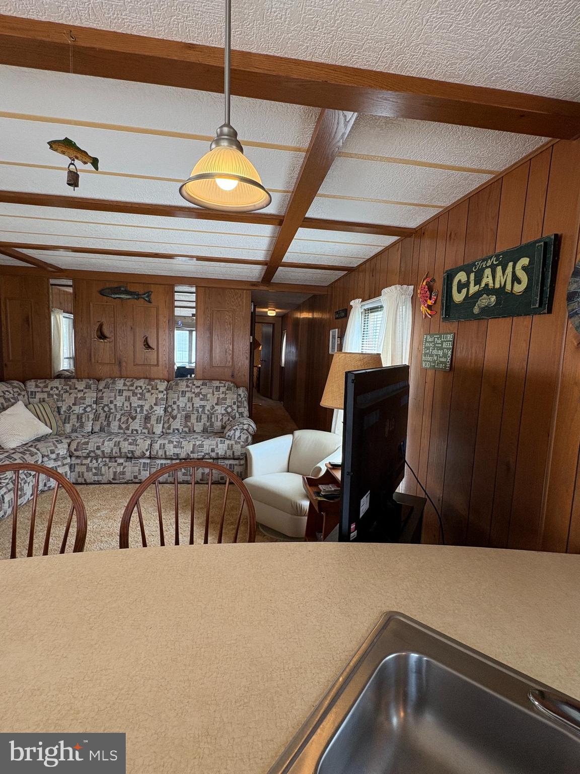 38354 Squirrel Road, Unit 19312 Ocean View, DE 19970 - Photo 19 of 39 a kitchen with a refrigerator and countertop