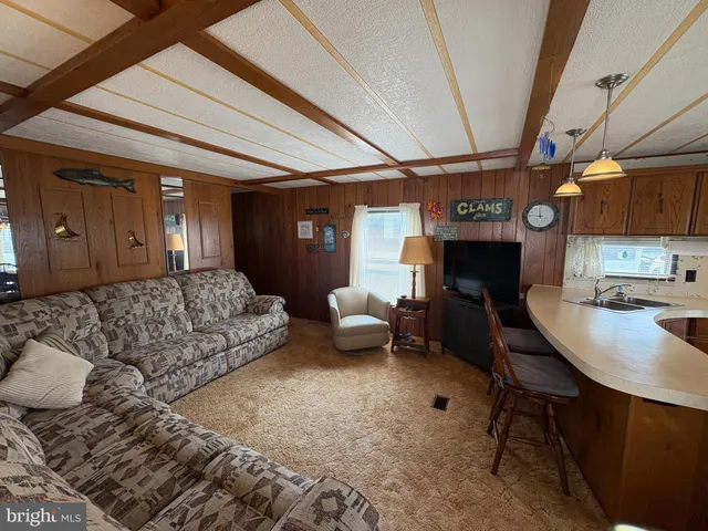 a living room with furniture and a dining table