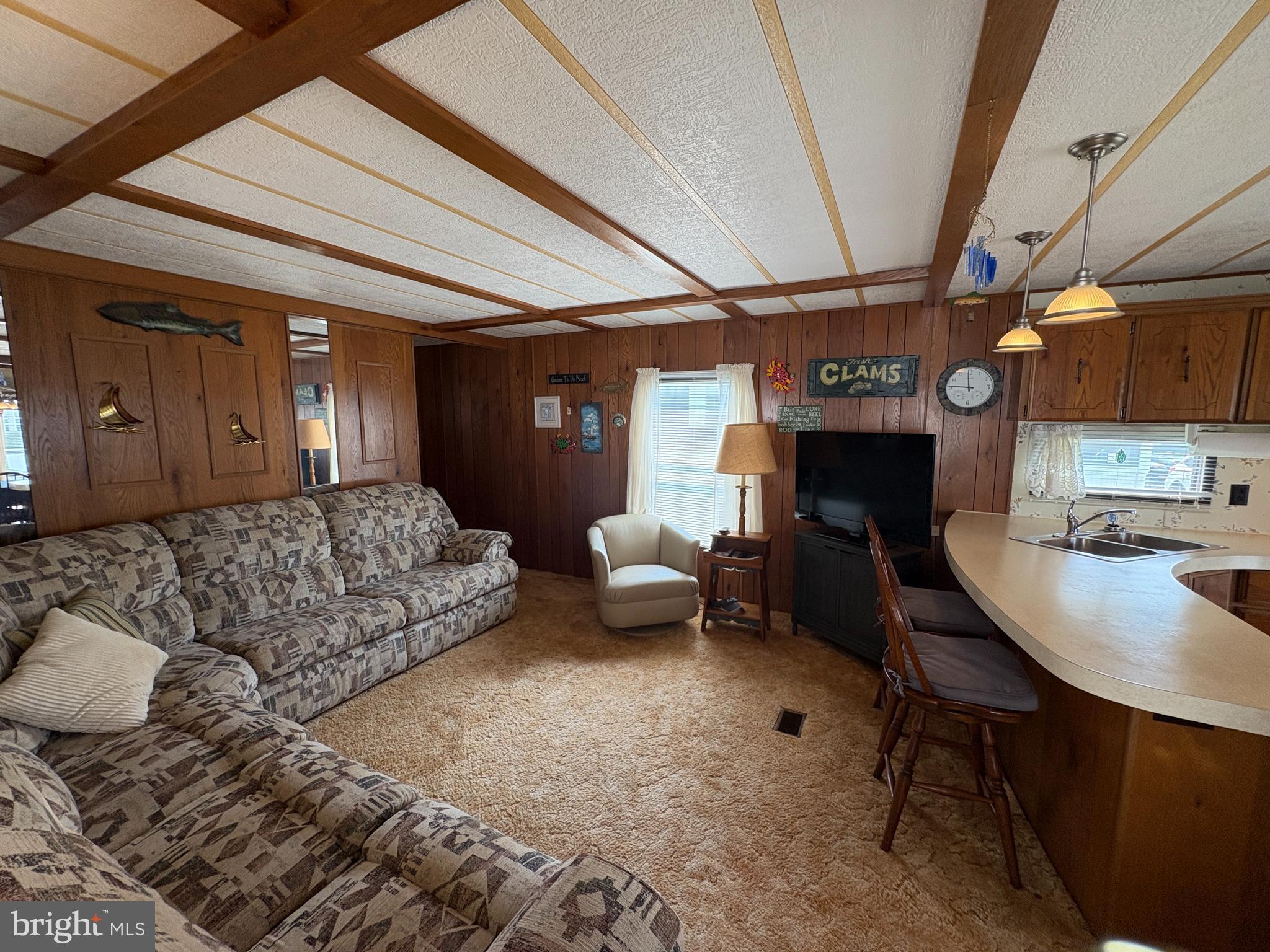 38354 Squirrel Road, Unit 19312 Ocean View, DE 19970 - Photo 20 of 39 a living room with furniture and a dining table