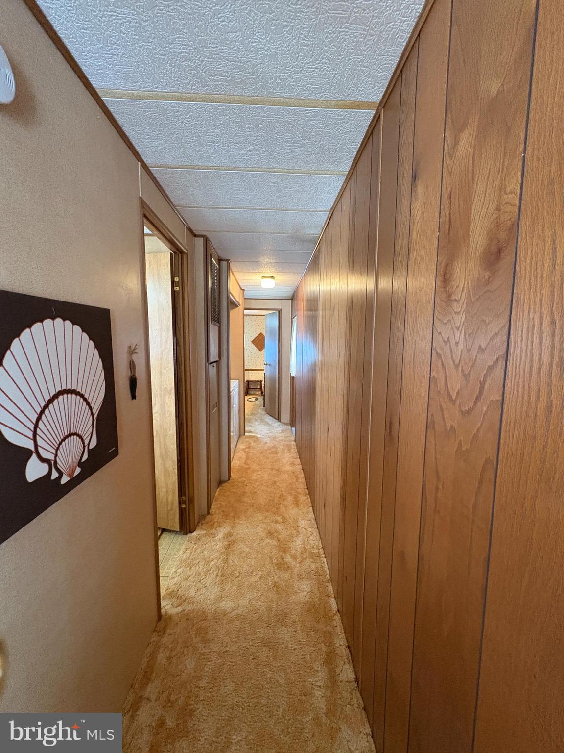 38354 Squirrel Road, Unit 19312 Ocean View, DE 19970 - Photo 23 of 39 a view of a hallway with a car parked in garage