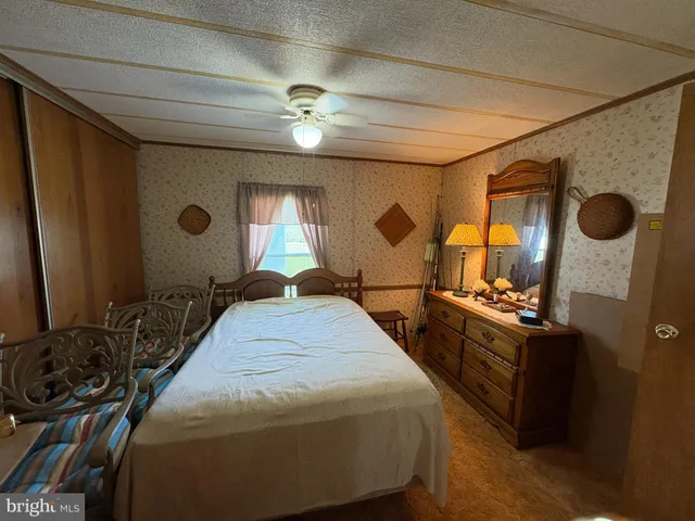 a bed room with a bed and a large mirror