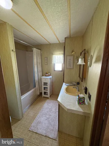 a room with sink washing machine and wooden floor