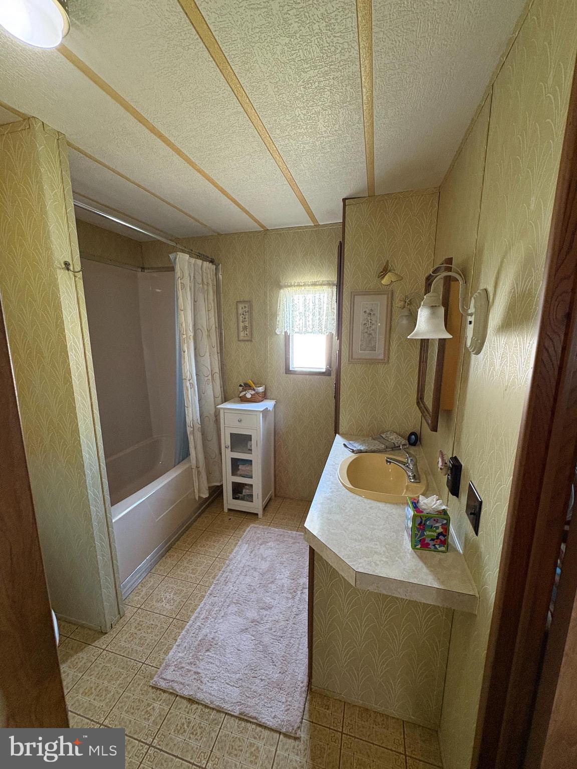 38354 Squirrel Road, Unit 19312 Ocean View, DE 19970 - Photo 37 of 39 a room with sink washing machine and wooden floor