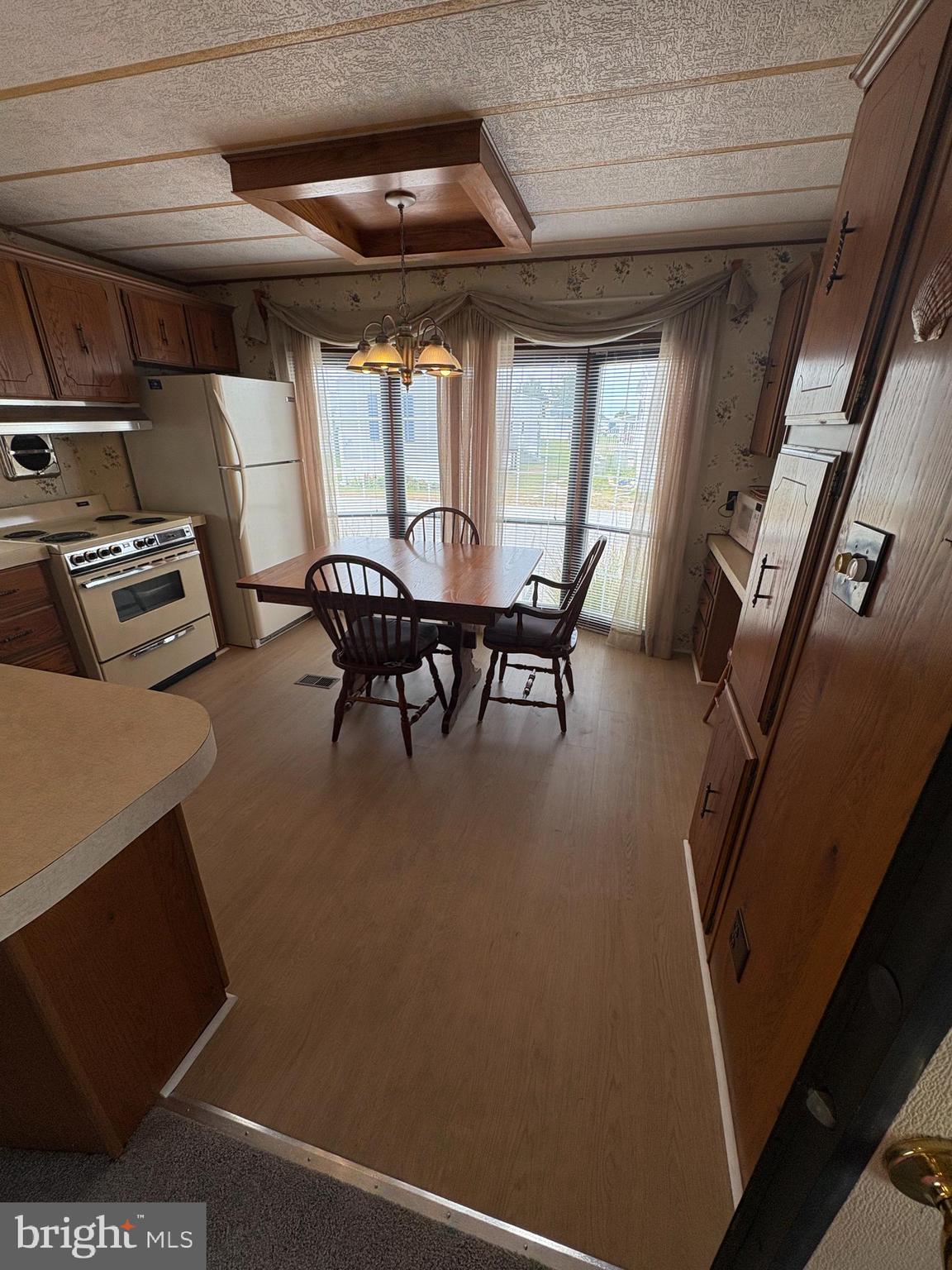 38354 Squirrel Road, Unit 19312 Ocean View, DE 19970 - Photo 4 of 39 a dining room with furniture and a floor to ceiling window