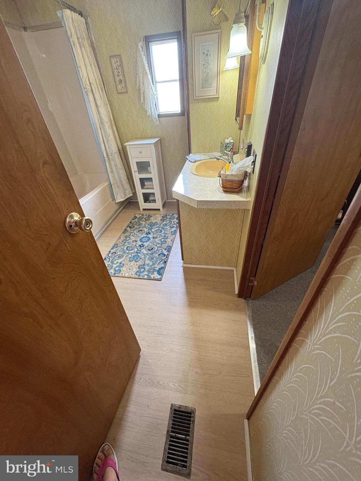 38354 Squirrel Road, Unit 19312 Ocean View, DE 19970 - Photo 5 of 39 a bathroom with a sink and a mirror
