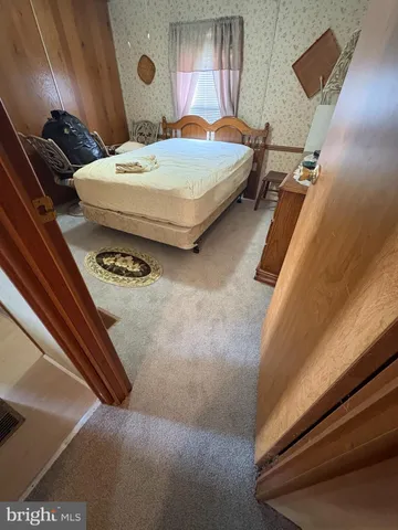 a bedroom with bed and a window