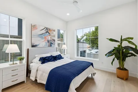 a bedroom with a bed and a potted plant