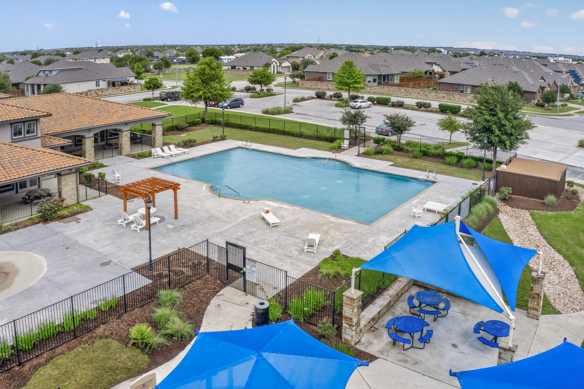16809 Guido Cove Pflugerville, TX 78660 - Photo 39 of 40 Community swimming pool with surrounding concrete decking, lounge areas, and a pergola